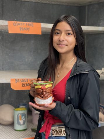 Junior Ceramics student, Julissa Delgado shows the mug that she just completed in Ms. Hernandezs class. 